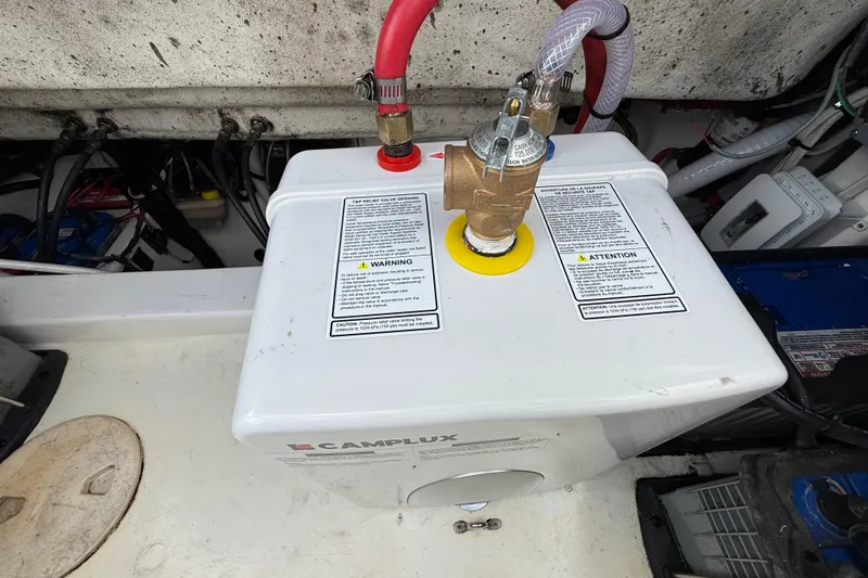 Slide: The Image of Camplux water heater in 2016 Extreme Boats XC38 engine compartment, featuring safety labels and connections. - 140