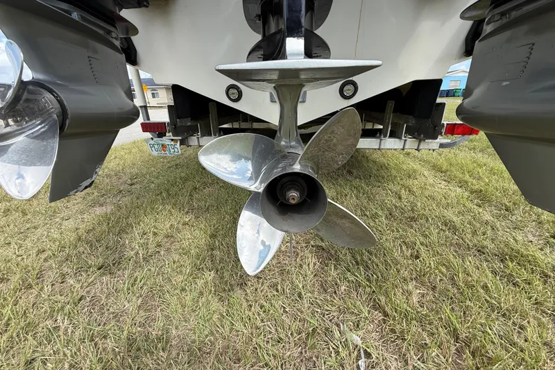 Slide: The Image of Propeller of 2016 Extreme Boats XC38 on grass, showcasing dual outboard motors. - 65