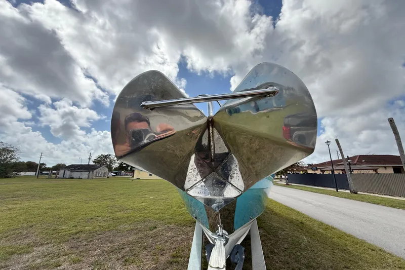 Slide: The Image of 2016 Extreme Boats XC38 with shiny anchor, parked on grass under cloudy sky. - 44