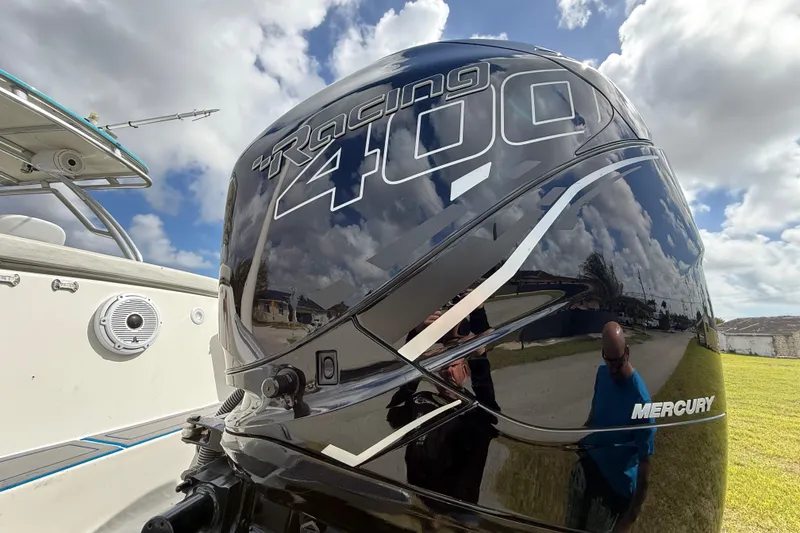 Slide: The Image of Mercury Racing 400 outboard engine on 2016 Extreme Boats XC38 under cloudy sky. - 64