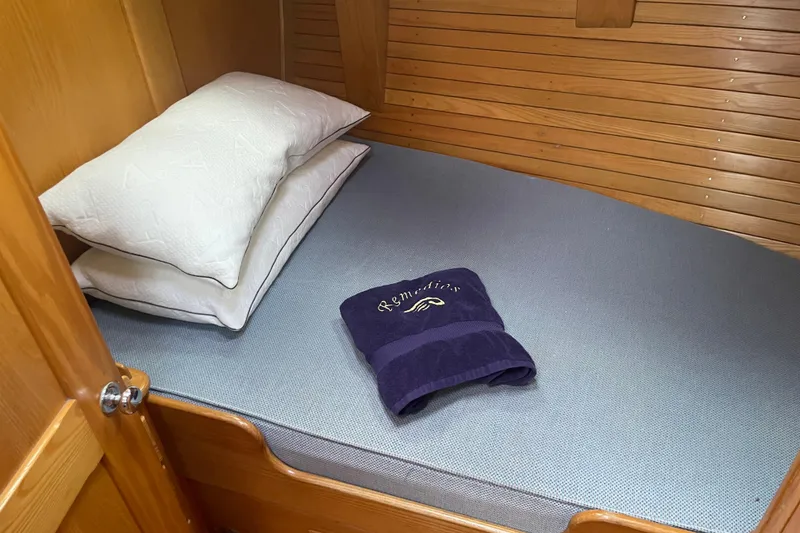 Slide: The Image of Cozy cabin bed with pillows and towel on 1985 Hinckley Sou'wester 59 yacht. - 18