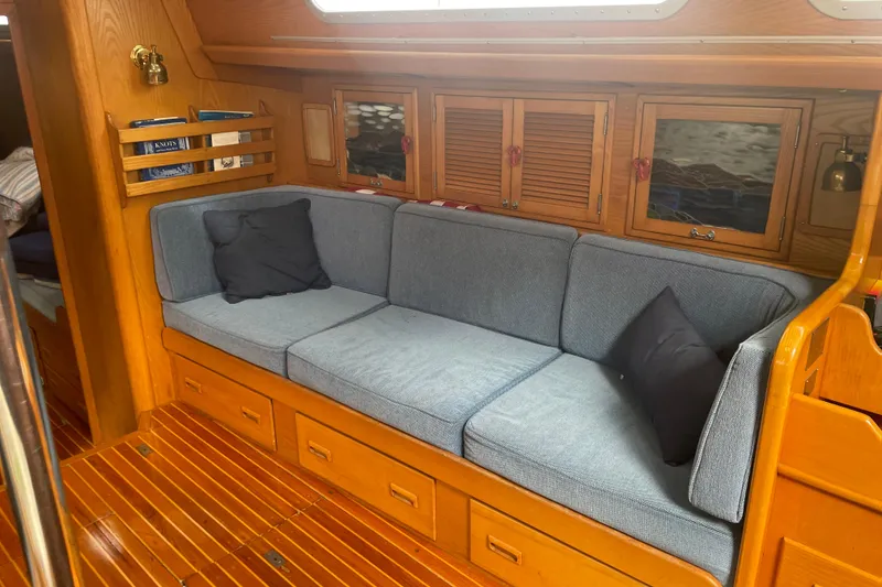 Slide: The Image of Interior of 1985 Hinckley Sou'wester 59 yacht with cozy seating and wooden cabinetry. - 13