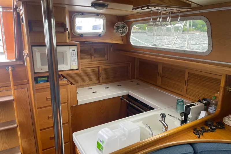 Slide: The Image of Interior of 1985 Hinckley Sou'wester 59 yacht kitchen with wooden cabinetry and appliances. - 15