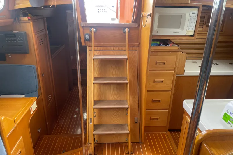 Slide: The Image of Interior of 1985 Hinckley Sou'wester 59 yacht with wooden stairs and cabinetry. - 14