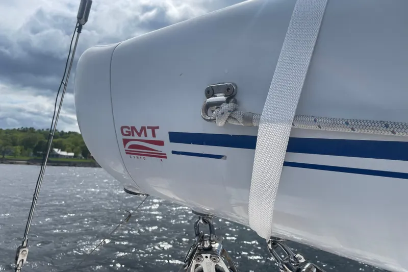Slide: The Image of Hinckley Sou'wester 59 sailboat mast detail with GMT logo, 1985 model, on water. - 10