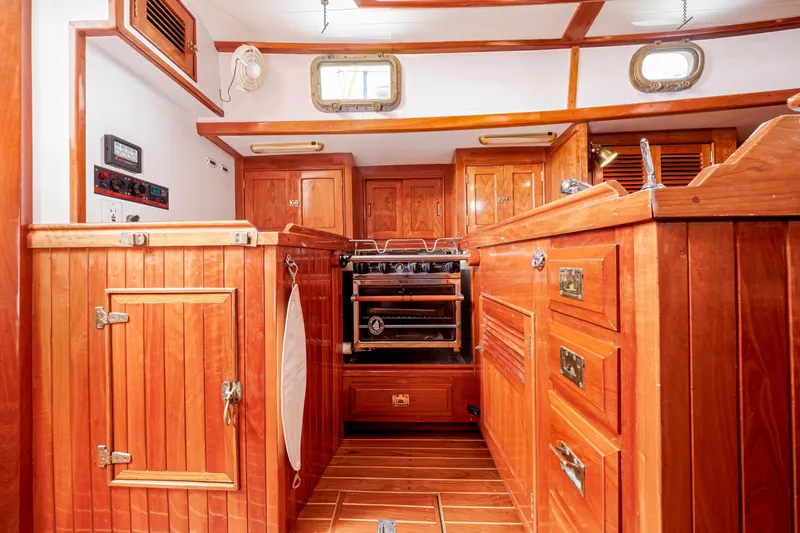 Slide: The Image of Luxurious wooden interior of a 2001 Shannon 47/52 yacht kitchen with stove and cabinets. - 40