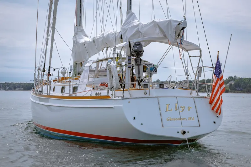 Slide: The Image of Sailing yacht Shannon 47/52, 2001 model, with American flag, docked in calm waters. - 17