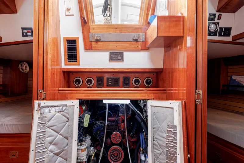 Slide: The Image of Engine room of a 2001 Shannon 47/52 yacht with wooden paneling and control gauges. - 63