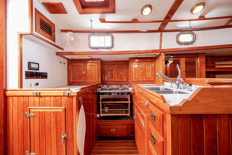 Slide: The Image of Luxurious wooden interior of a 2001 Shannon 47/52 yacht kitchen with stove and sink. - 39