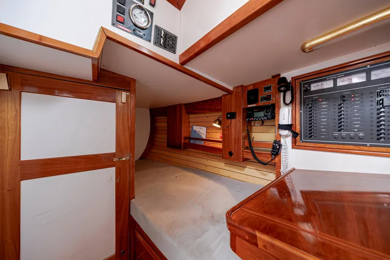 Slide: The Image of Interior of a 2001 Shannon 47/52 yacht featuring a cozy cabin with control panels. - 43