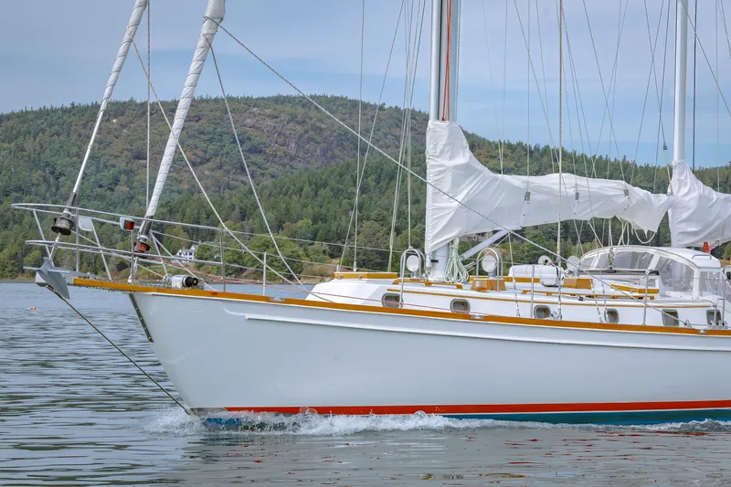 Slide: The Image of Sailing yacht Shannon 47/52 from 2001 cruising on a serene lake with forested hills. - 15