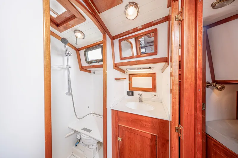 Slide: The Image of Luxurious wooden yacht bathroom with shower, sink, and mirror on a 2001 Shannon 47/52 model. - 46
