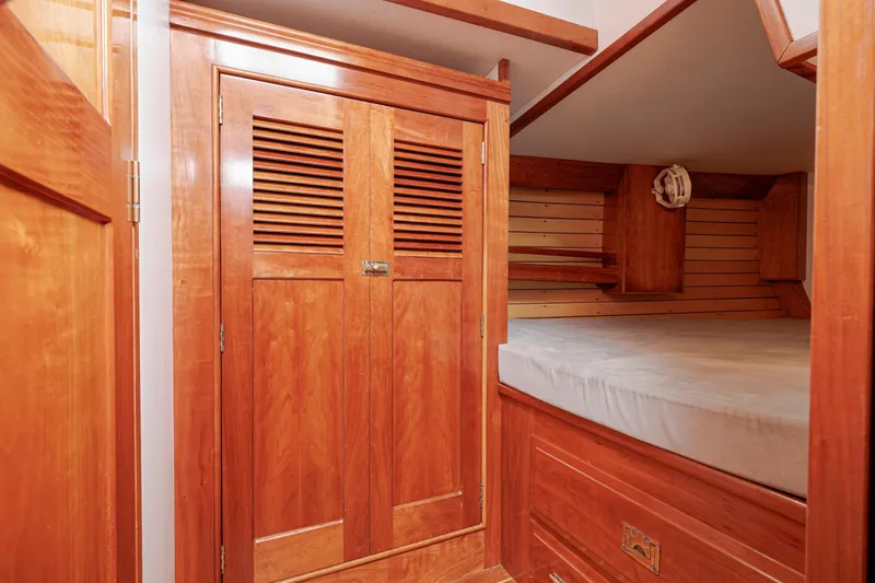 Slide: The Image of Wooden cabin interior of 2001 Shannon 47/52 yacht with bed and storage. - 47