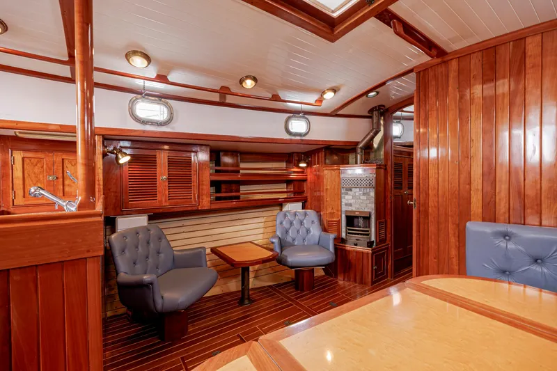 Slide: The Image of Luxurious wooden interior of a 2001 Shannon 47/52 yacht with plush seating and elegant design. - 49