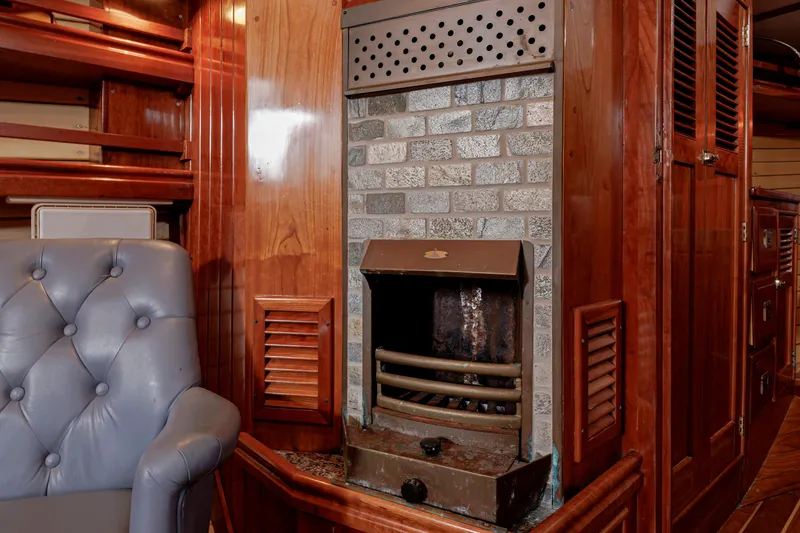 Slide: The Image of Luxurious wooden interior of a 2001 Shannon 47/52 yacht with a cozy fireplace. - 56