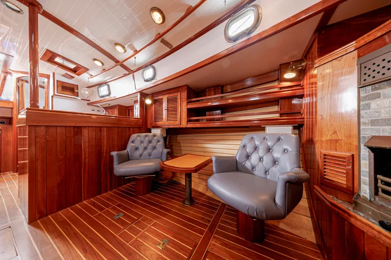 Slide: The Image of Luxurious wooden interior of a 2001 Shannon 47/52 yacht with plush seating and elegant design. - 51