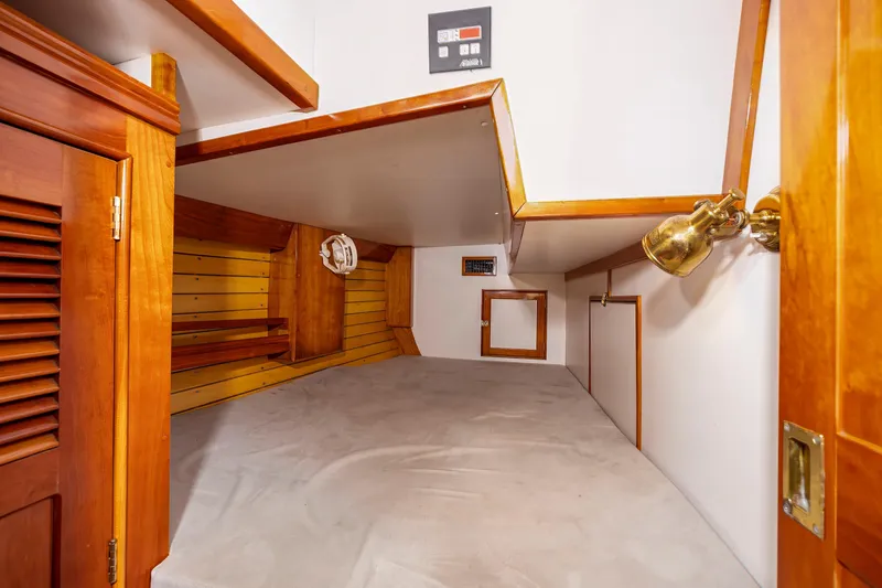 Slide: The Image of Cozy cabin interior of 2001 Shannon 47/52 yacht with wooden accents and lighting. - 48