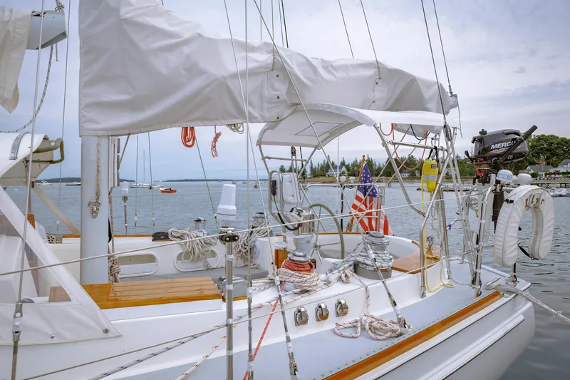 Slide: The Image of Sailboat docked at marina, Shannon 47/52 model, 2001, with American flag and outboard motor. - 19