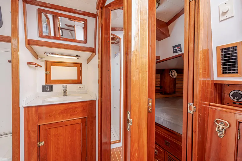 Slide: The Image of Luxurious wooden interior of a 2001 Shannon 47/52 yacht, featuring a compact bathroom and cozy cabin. - 45