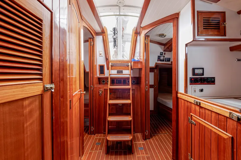 Slide: The Image of Luxurious wooden interior of a 2001 Shannon 47/52 yacht, featuring elegant cabinetry and stairs. - 34