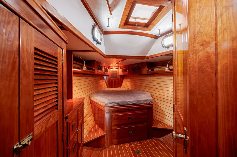 Slide: The Image of Luxurious wooden cabin interior of a 2001 Shannon 47/52 yacht with cozy bed and storage. - 57