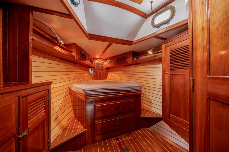 Slide: The Image of Luxurious wooden cabin interior of a 2001 Shannon 47/52 yacht, featuring elegant wood paneling. - 58