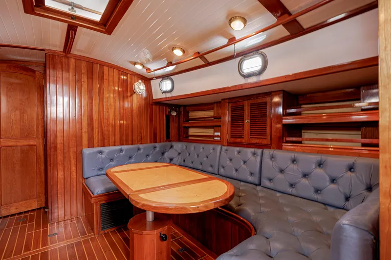 Slide: The Image of Luxurious wooden interior of a 2001 Shannon 47/52 yacht with plush seating and elegant design. - 53