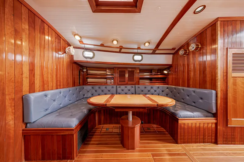 Slide: The Image of Luxurious wooden yacht interior with plush seating, featuring Shannon 47/52 model from 2001. - 54