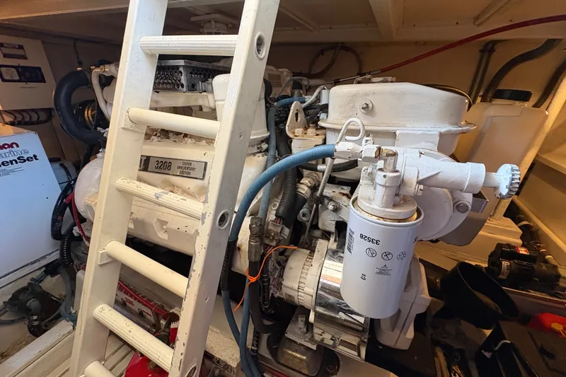 Slide: The Image of Engine room of a 1996 Grand Banks 40 Eastbay EX with visible machinery and ladder. - 43