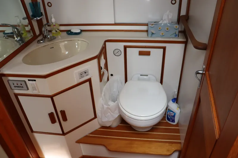 Slide: The Image of Bathroom interior of 1996 Eastbay 40 Express Grand Banks yacht, featuring sink and toilet. - 22