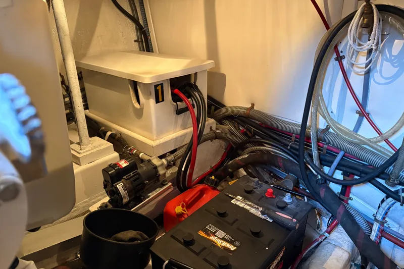 Slide: The Image of Engine room of a 1996 Grand Banks 40 Eastbay EX with battery and wiring. - 42