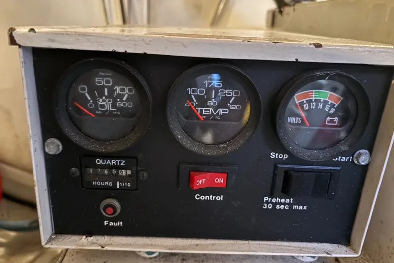 Slide: The Image of Instrument panel of a 1996 Grand Banks 40 Eastbay EX, displaying oil, temperature, and voltage gauges. - 39