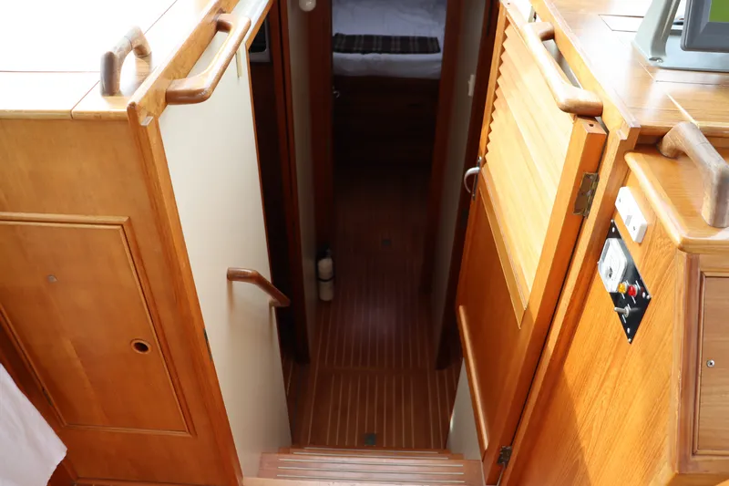 Slide: The Image of Interior view of 1996 Eastbay 40 Express Grand Banks yacht, featuring wooden stairs and cabinetry. - 20