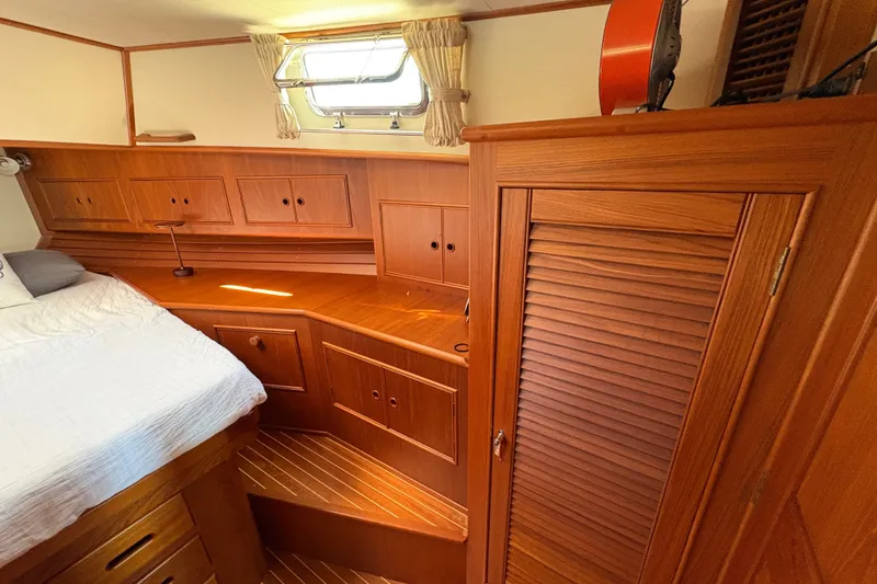 Slide: The Image of Cozy cabin interior of 1996 Grand Banks 40 Eastbay EX with wooden cabinetry and bed. - 31