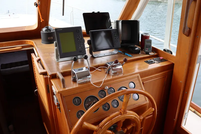 Slide: The Image of Helm of 1996 Eastbay 40 Express Grand Banks with navigation equipment and wooden steering wheel. - 15