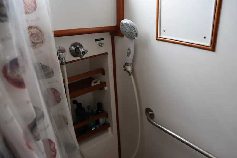 Slide: The Image of Shower area in 1996 Eastbay 40 Express Grand Banks yacht with curtain and toiletries. - 23
