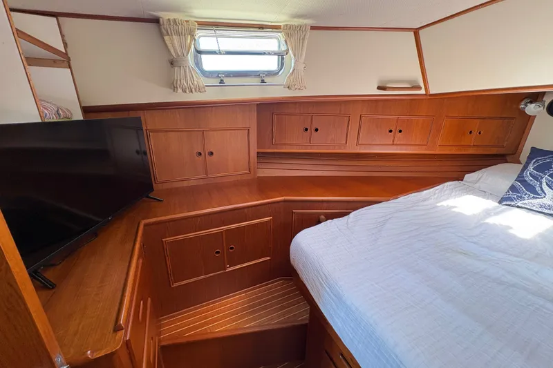 Slide: The Image of Cozy cabin interior of 1996 Grand Banks 40 Eastbay EX with wood finish and TV. - 33