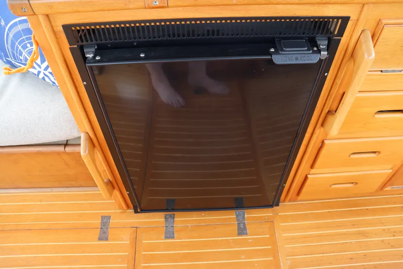 Slide: The Image of Wooden interior of 1996 Eastbay 40 Express Grand Banks yacht with built-in fridge. - 13