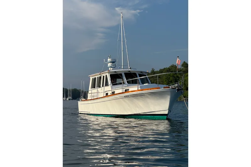 The Image of 1996 Eastbay 40 Express Grand Banks yacht on calm water, clear sky background. - 0