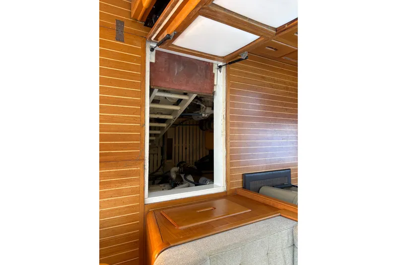 Slide: The Image of Interior view of 1996 Grand Banks 40 Eastbay EX with wooden paneling and engine access. - 37