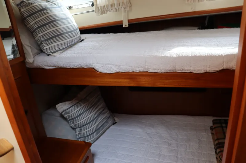 Slide: The Image of Interior cabin of 1996 Eastbay 40 Express Grand Banks with bunk beds and striped pillows. - 21