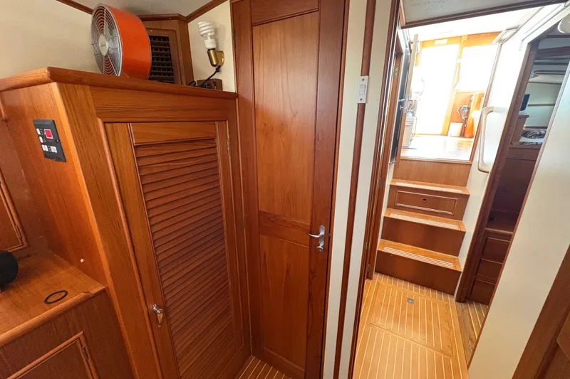 Slide: The Image of Interior of 1996 Grand Banks 40 Eastbay EX with wooden cabinetry and stairs. - 35