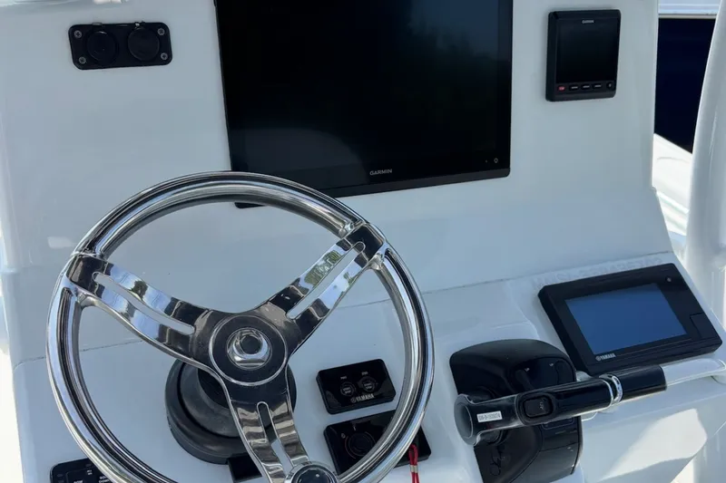 Slide: The Image of Steering console of 2021 Yellowfin 26 Hybrid boat with Garmin and Yamaha displays. - 15