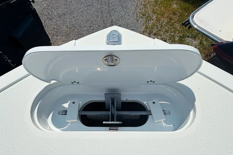 Slide: The Image of Open anchor compartment on 2021 Yellowfin 26 Hybrid boat, showcasing storage design. - 23