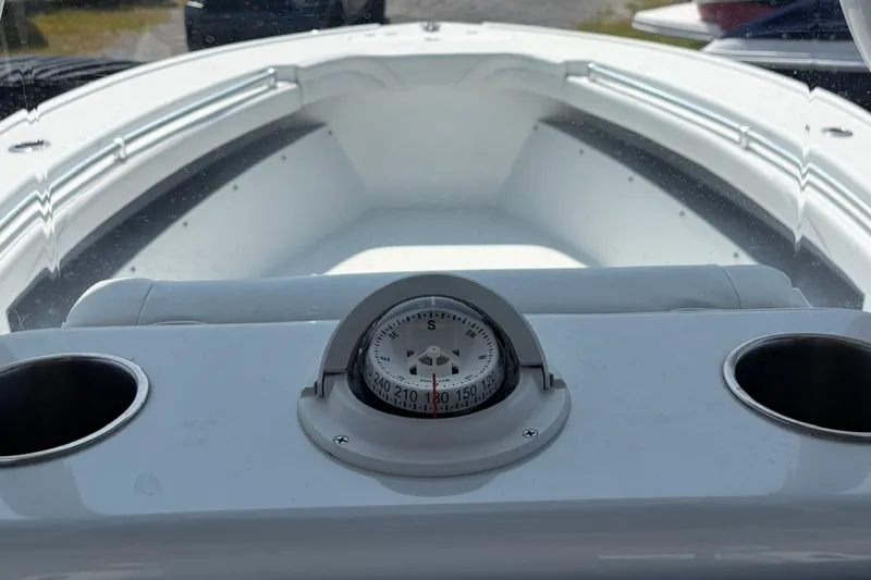 Slide: The Image of 2021 Yellowfin 26 Hybrid boat interior with compass and cup holders. - 13