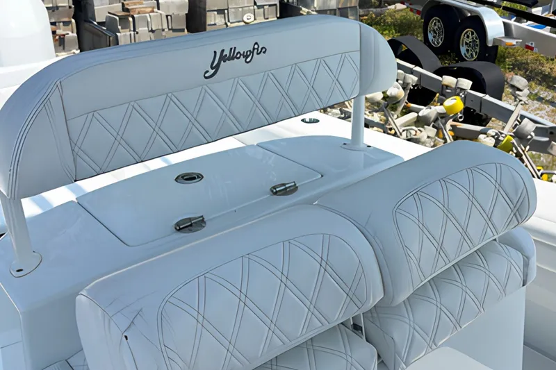 Slide: The Image of 2021 Yellowfin 26 Hybrid boat seating with diamond-stitched upholstery and storage compartment. - 16