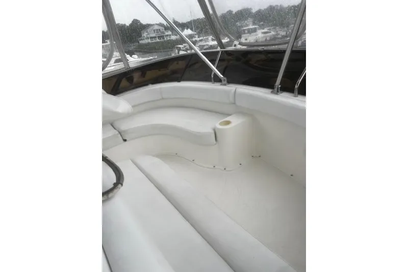 Slide: The Image of 1996 Silverton 41 Convertible boat interior with white seating and cup holder. - 13