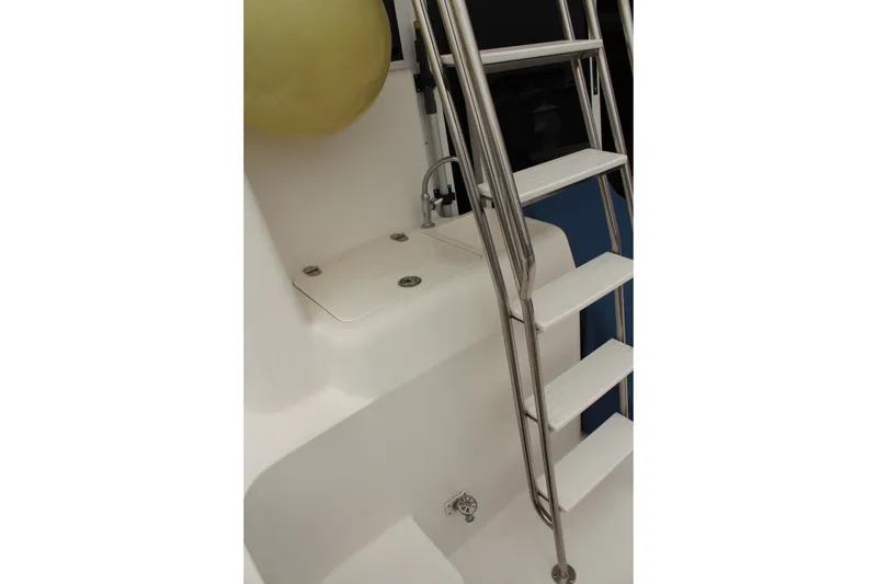 Slide: The Image of Stainless steel ladder on 1996 Silverton 41 Convertible yacht, featuring white steps and deck. - 40
