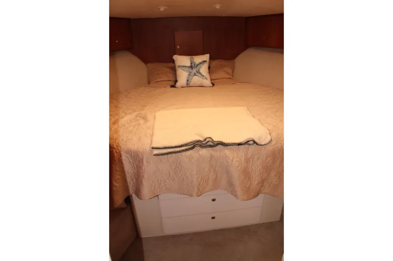 Slide: The Image of Cozy bedroom in 1996 Silverton 41 Convertible yacht with elegant bedding and starfish pillow. - 29