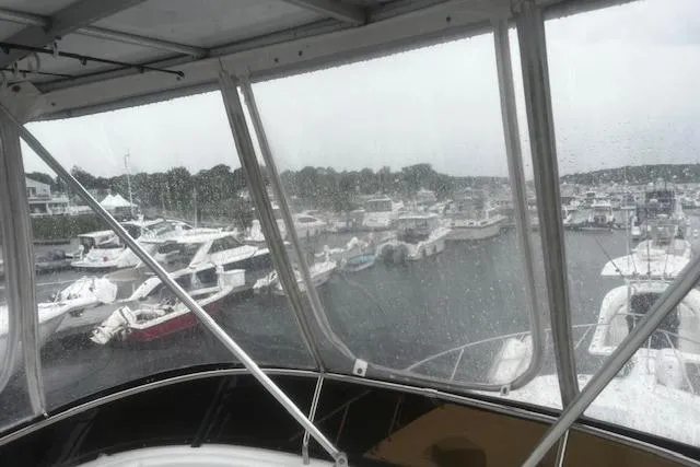 Slide: The Image of View from a 1996 Silverton 41 Convertible yacht overlooking a rainy marina. - 4